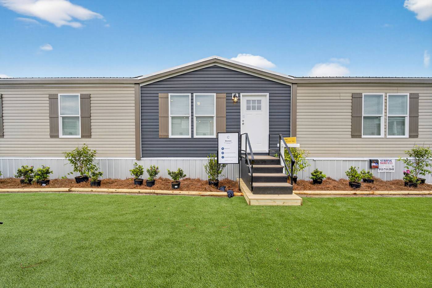 HUD-code double wide manufactured home with landscaped yard